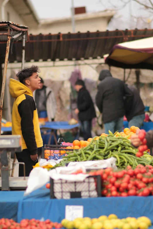 a man looks up at a fresh fruit display in front of him