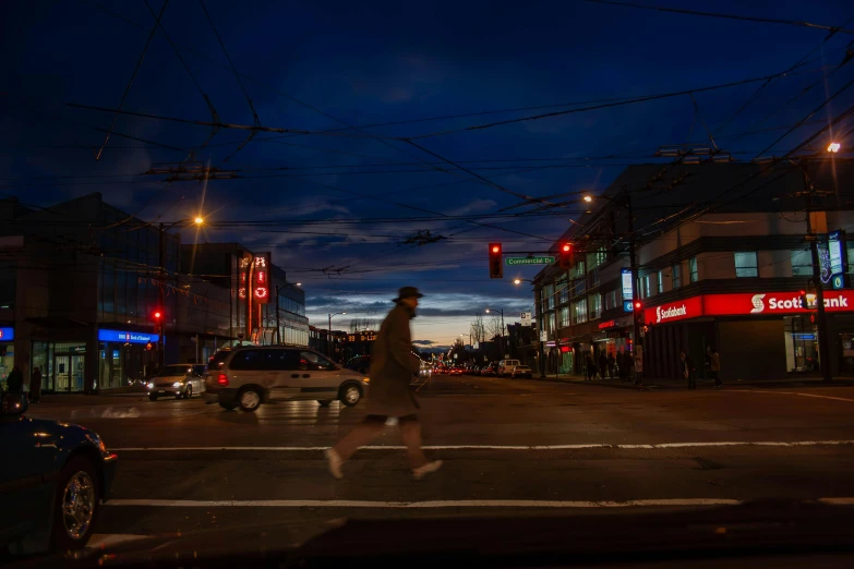 the intersection at night time, with traffic lights and streetlights