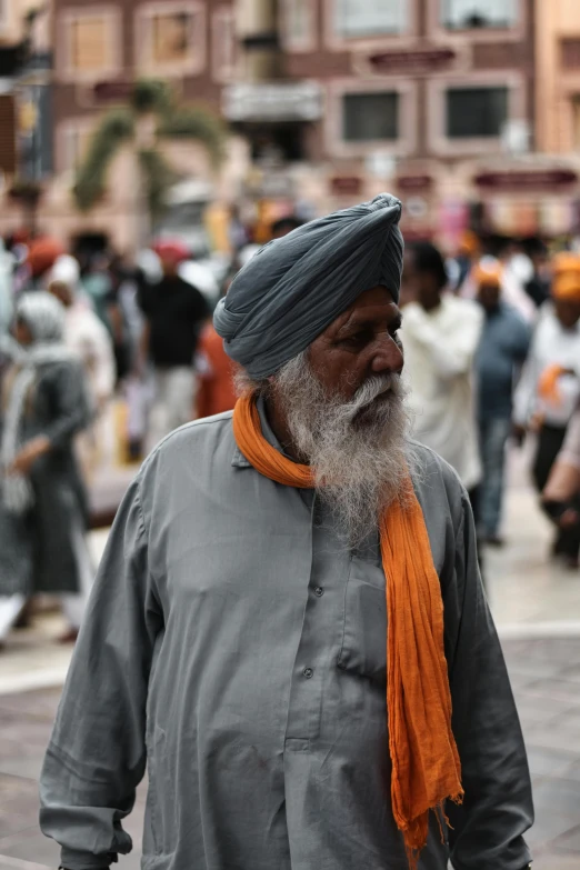 a man with white beard and a long orange tie