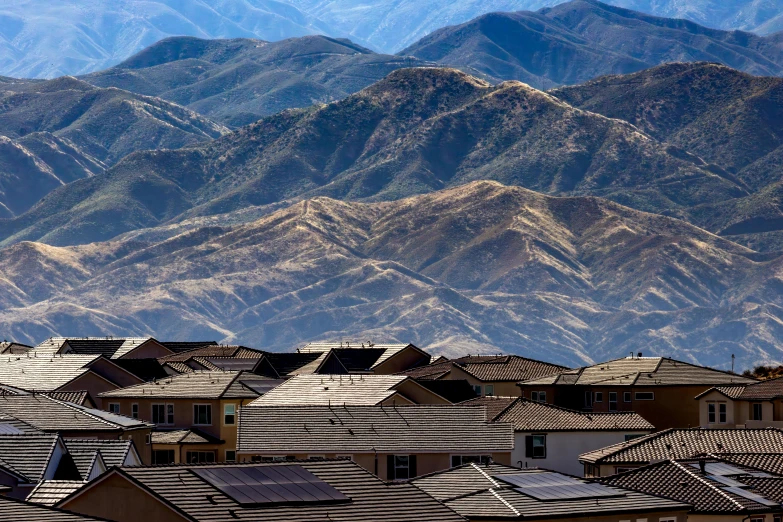 a town in the desert with mountain backdrop