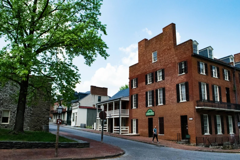 a very old brick building on the corner of the street