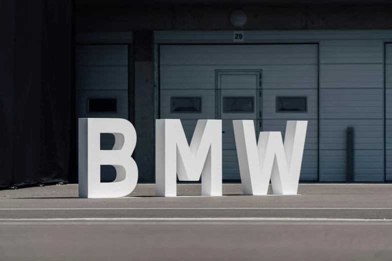 a tall letters sitting on the side of a road