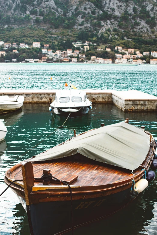 a row of boats sit in the middle of a body of water