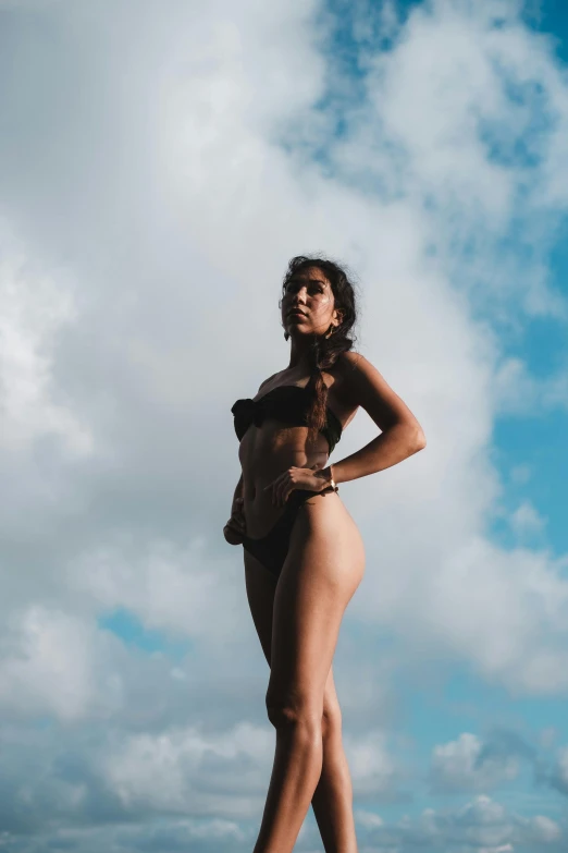 a  woman is posing for a po on the beach