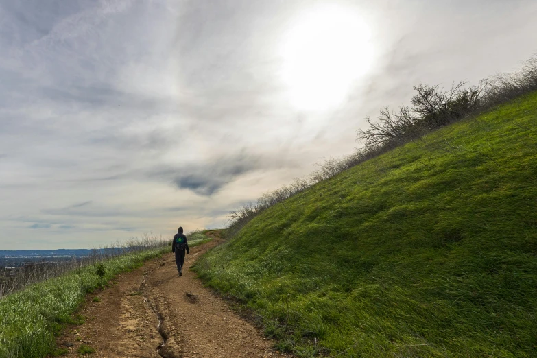 a man is walking along the path towards the camera