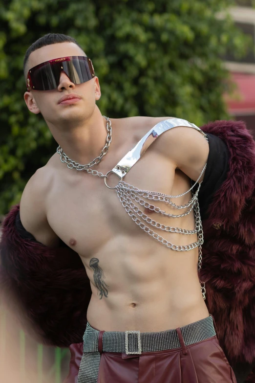 a man with sunglasses and chain attached to his chest