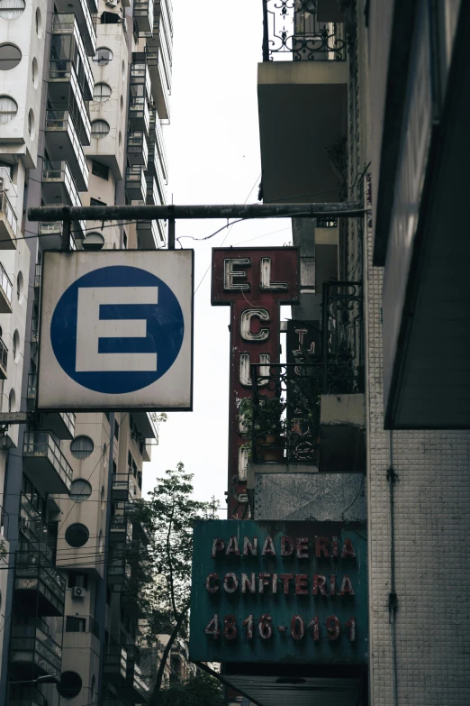 a sign hanging from the side of a building