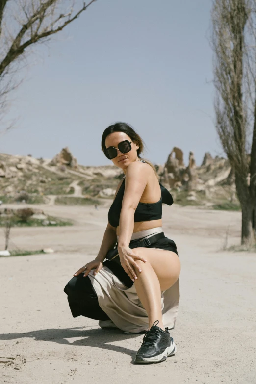 a woman in a black top and a black bag