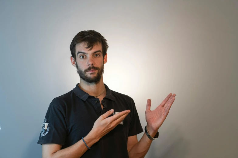 man in a black shirt with hand out for handshake