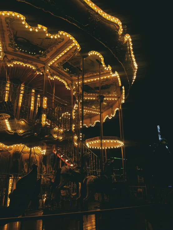 a colorfully lit merry go round in the dark