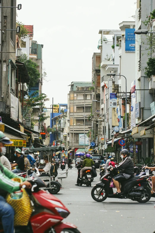 several people ride motorcycles on the street