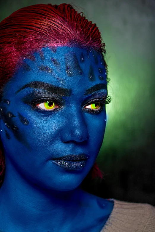 a woman with blue paint on her face is posed