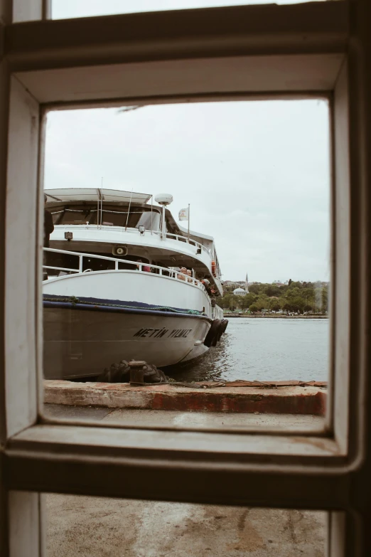 a big white boat docked near the water