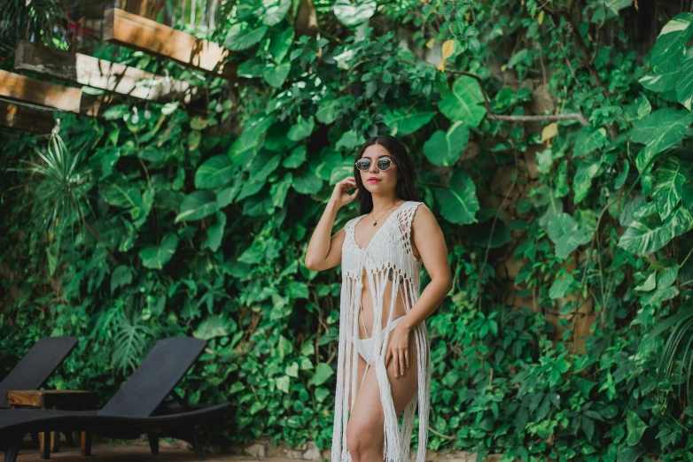 an asian lady wearing a fringe dress talking on her cell phone