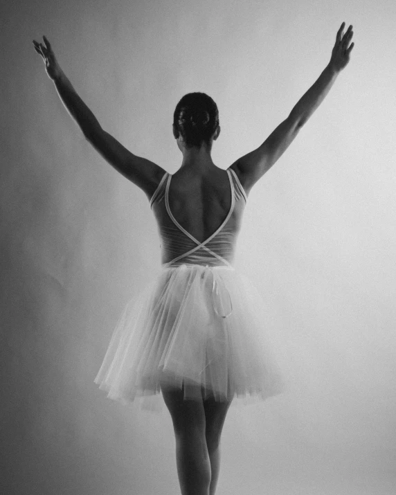 a woman dressed in ballet attire is dancing