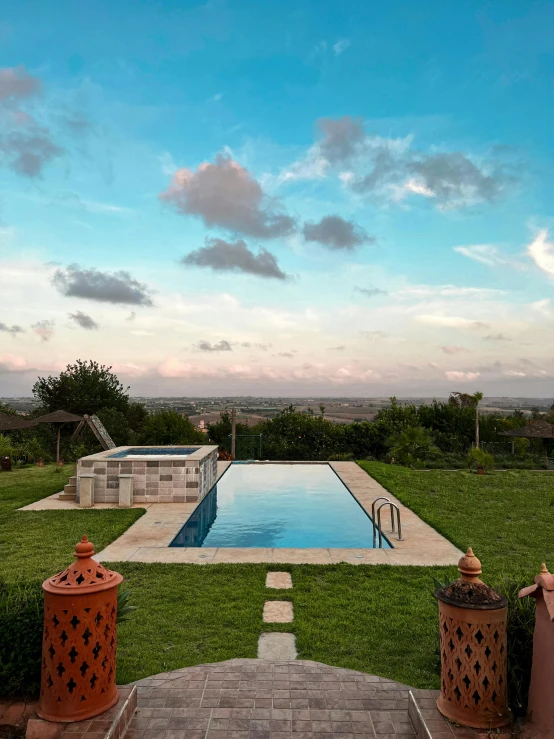 this is an image of a backyard with pool and fence