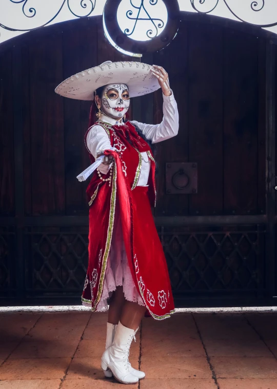 a woman with white face paint and a mexican mask