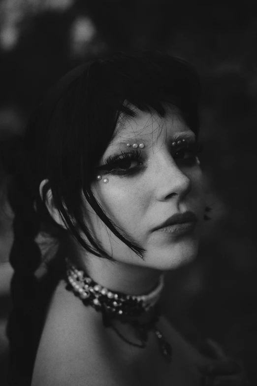 black and white po of a woman with necklaces and headpiece