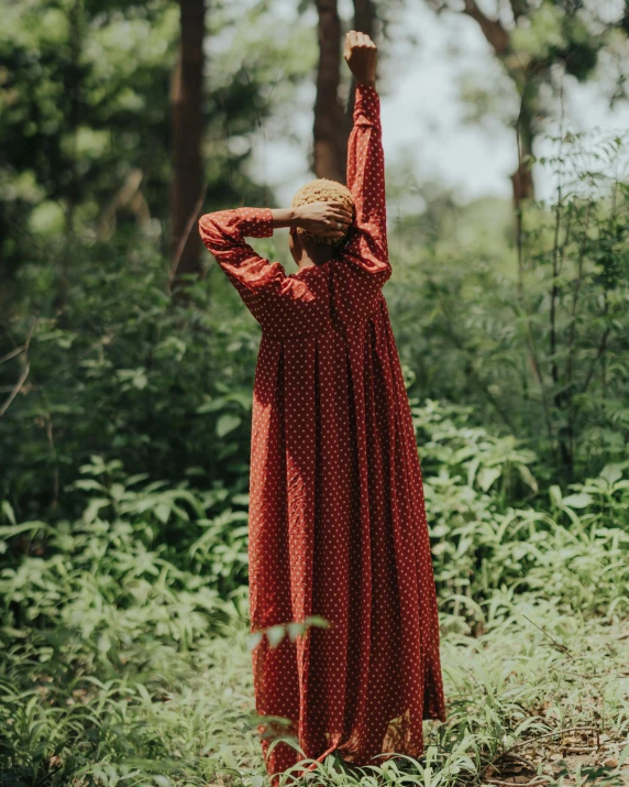 a woman walking in a lush green forest