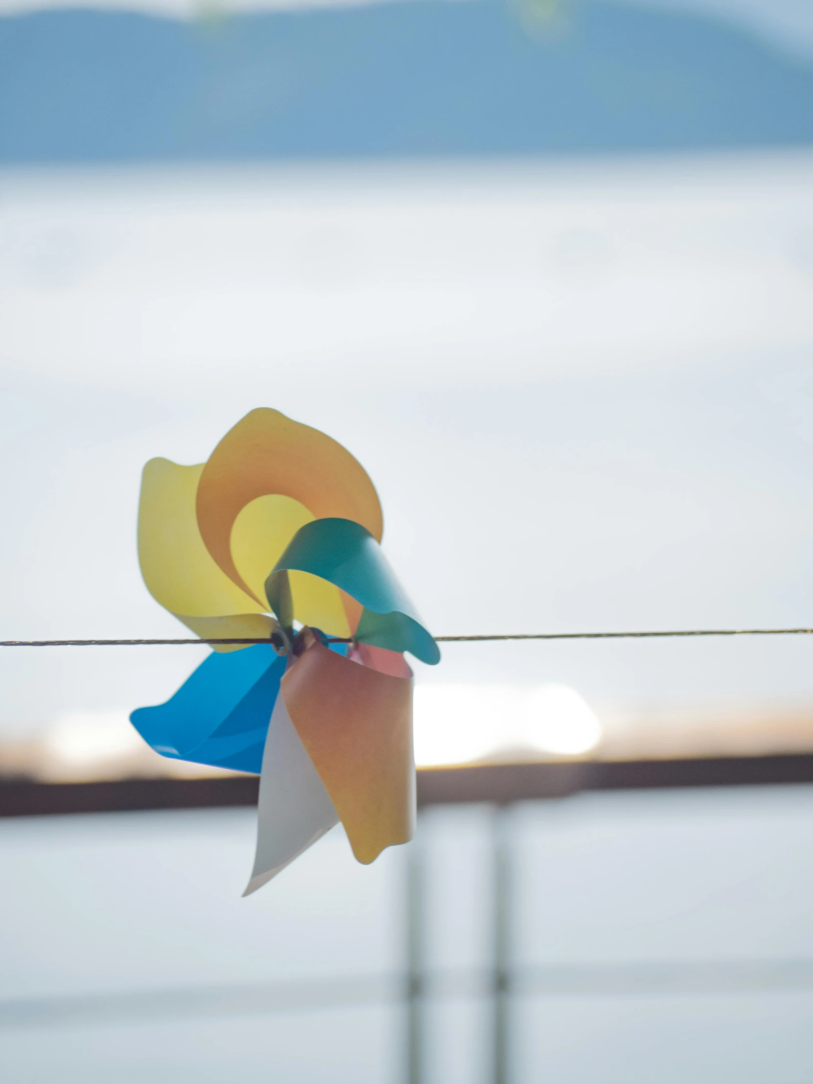 a close up of a wind turbine hanging on a wire