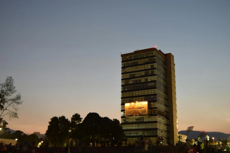 a tall building with an advertit on the top