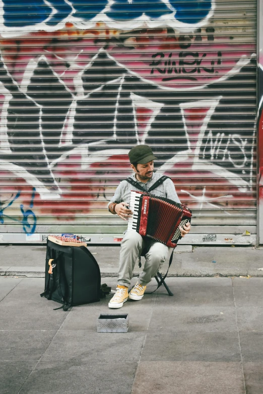 a person sitting on a bench and playing an accordion