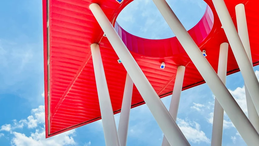 a red wind indicator with white poles and wires