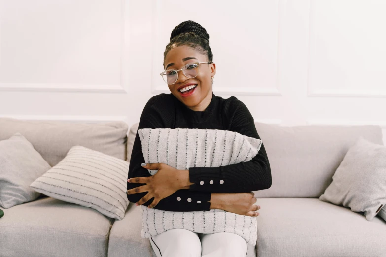 a black and white po of an african american woman sitting on a white couch