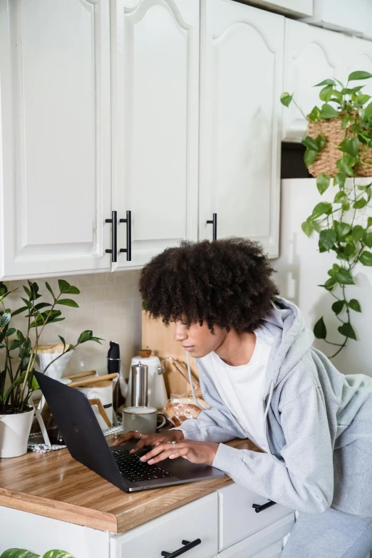 a person is sitting in front of a laptop