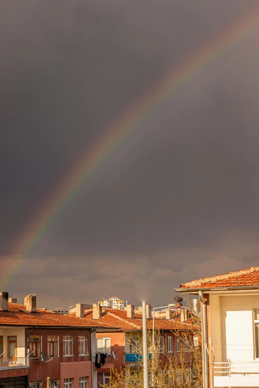 a rainbow seen behind houses in a residential area