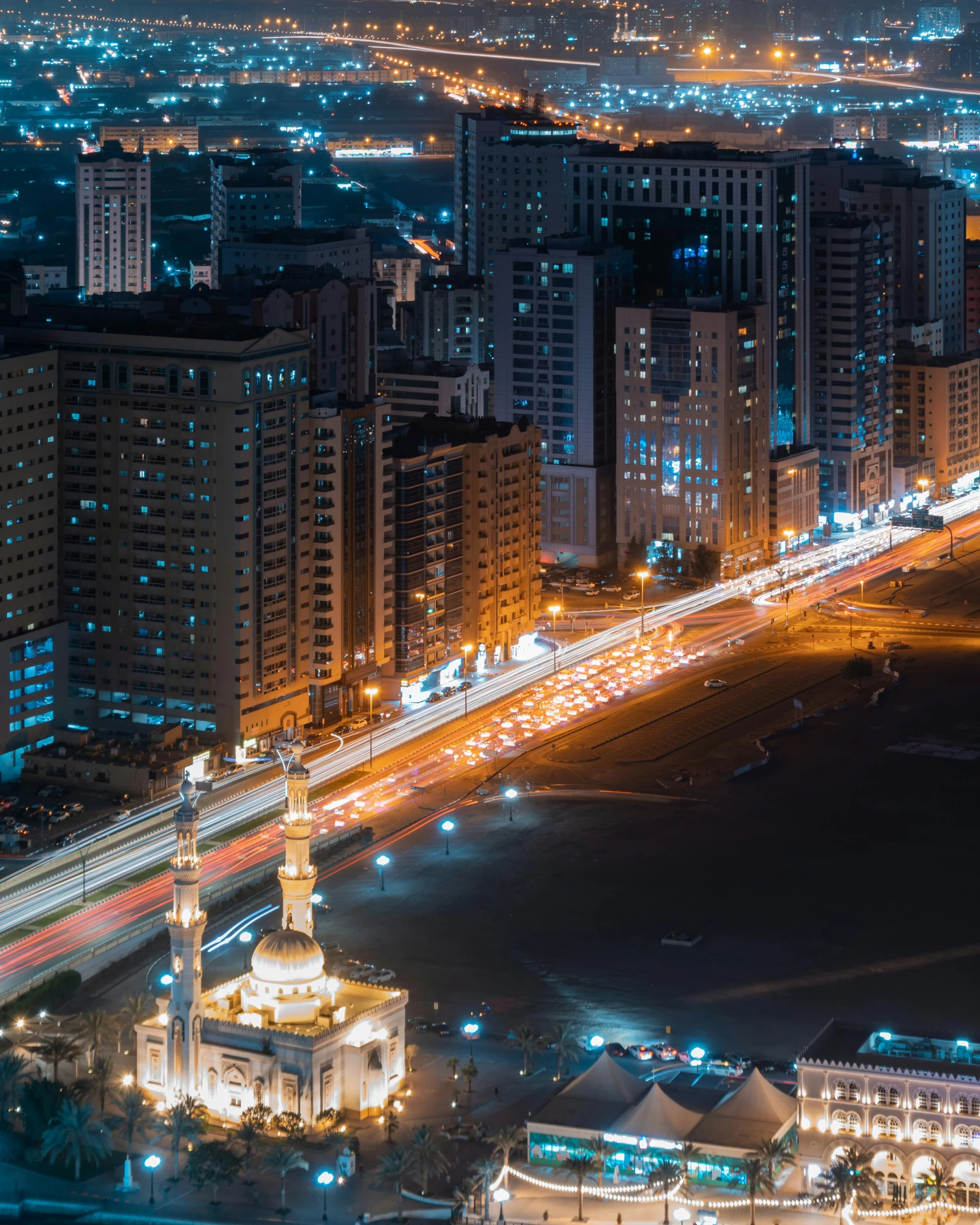 the night scene of a cityscape with many tall buildings