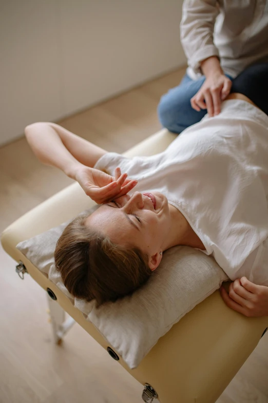 a woman lying down on a back cushion on a couch