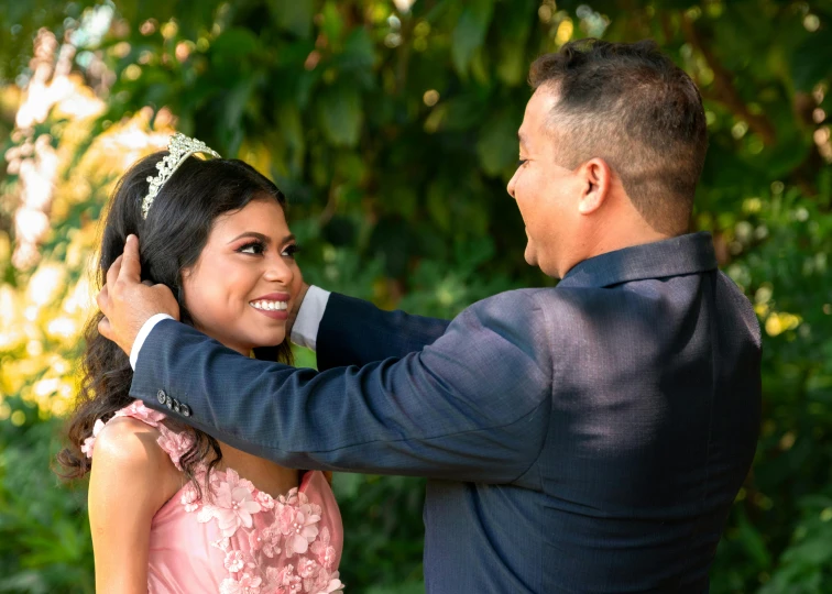 a man fixing the collar of his bride