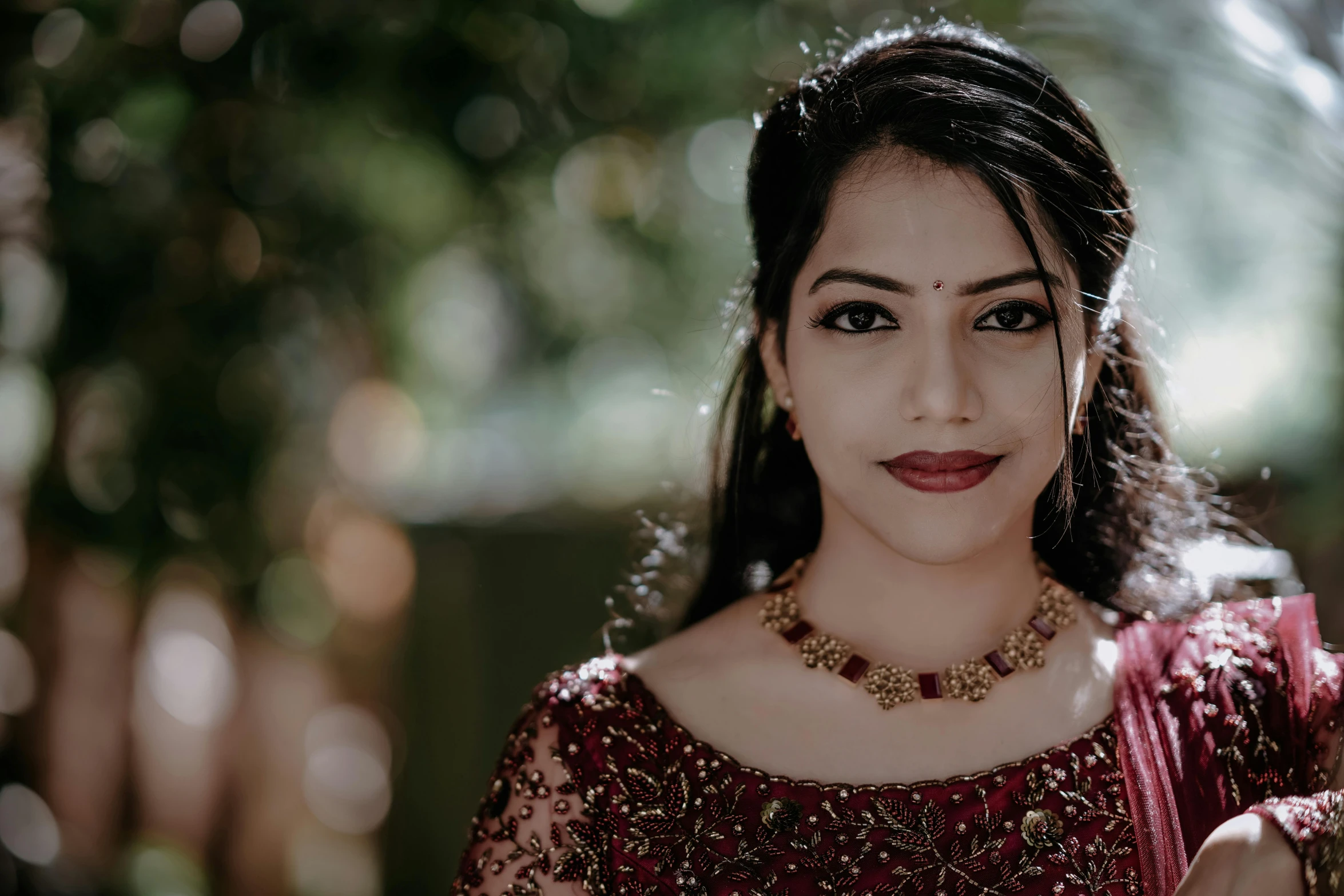 a woman is wearing a traditional indian outfit