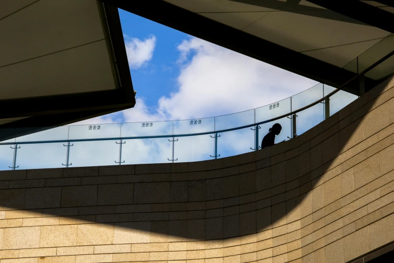 a person standing near a building looking at a sky line