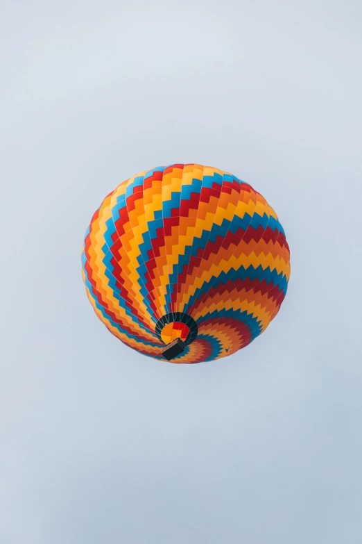 a colorful air balloon floating in the sky