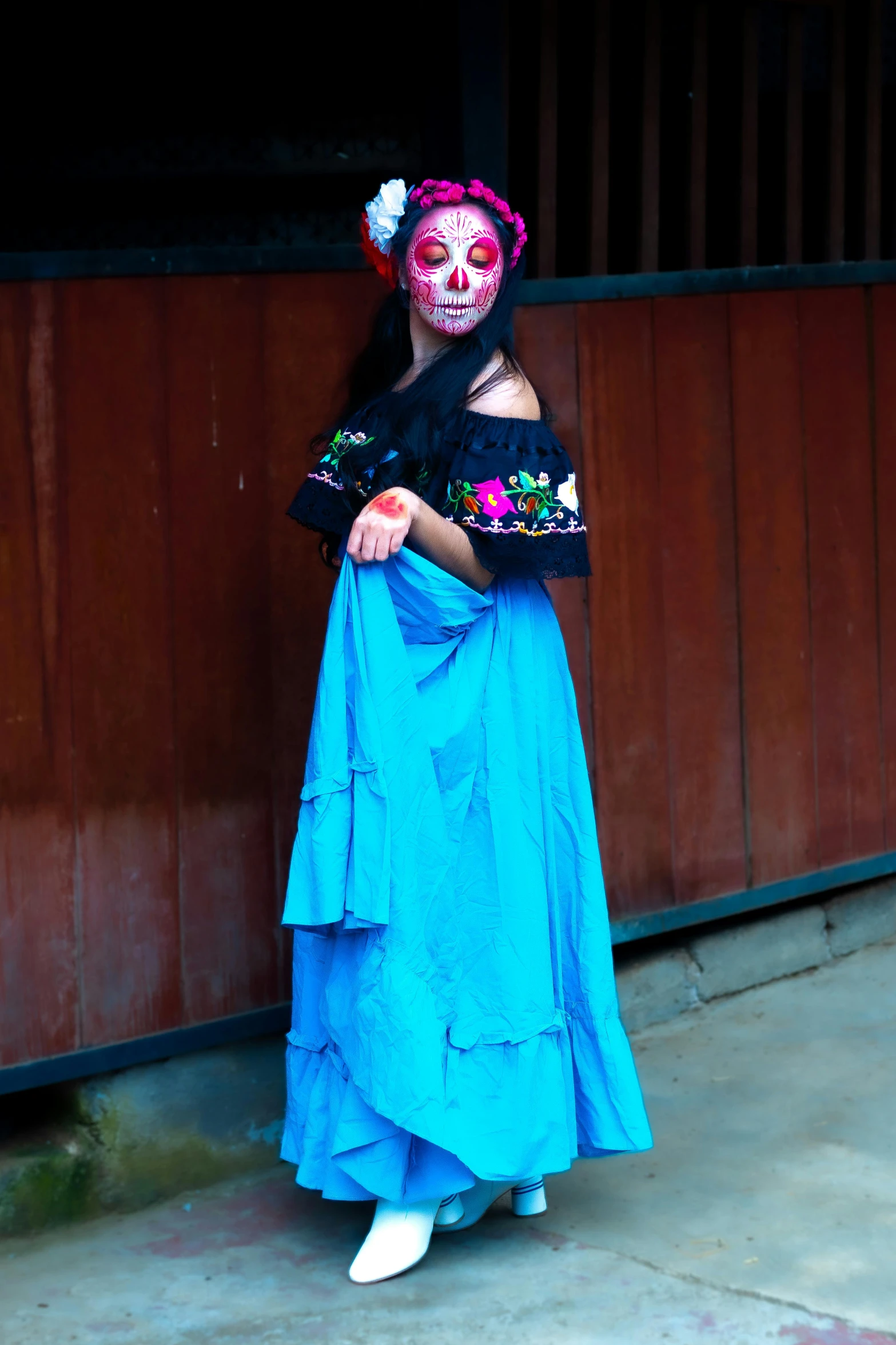 a  wearing mexican clothing standing outside