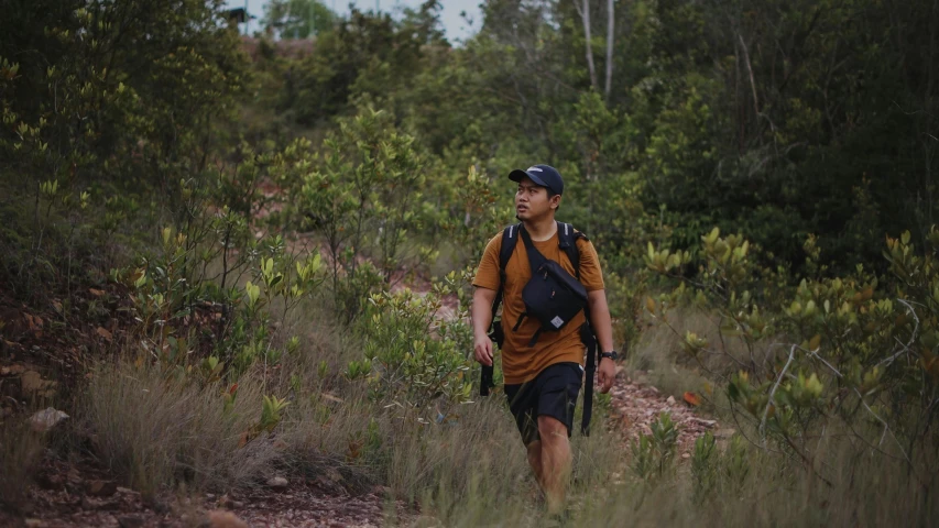 a man with a backpack walking down a path