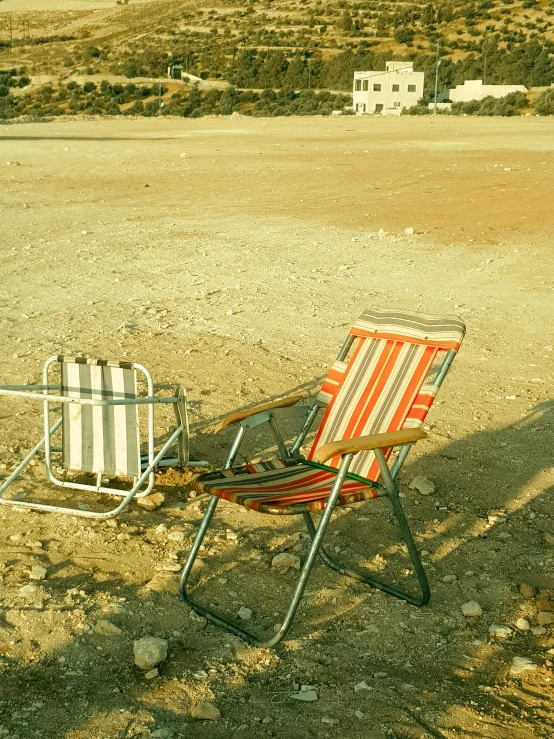 a chair with a cover on its back in a field