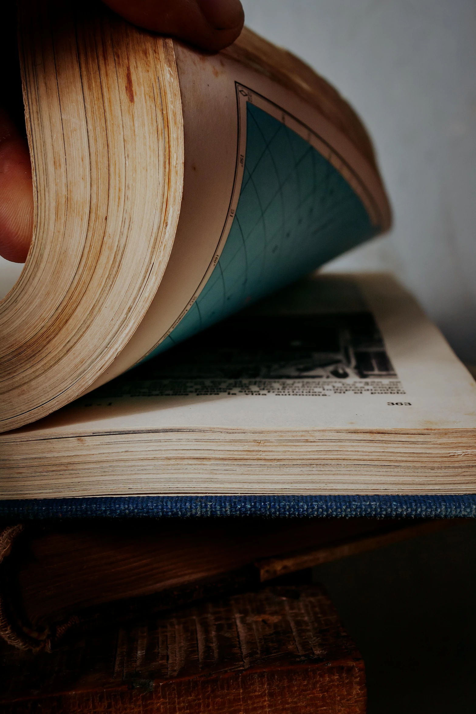 a person holds their hand over the pages of a book