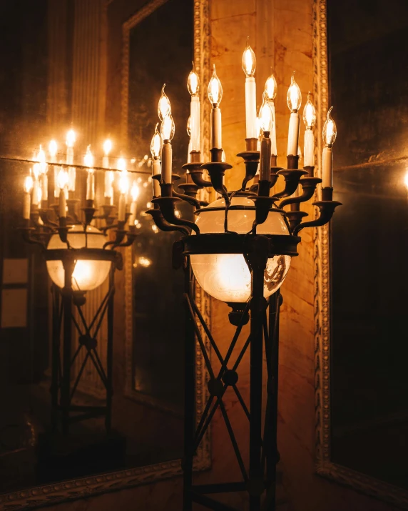 a candle lit chandelier with five candles on each end