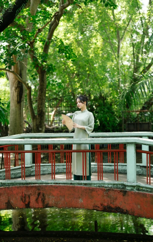 a woman is standing on top of the bridge