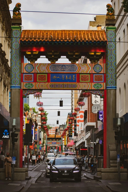 an oriental arch and city street with cars