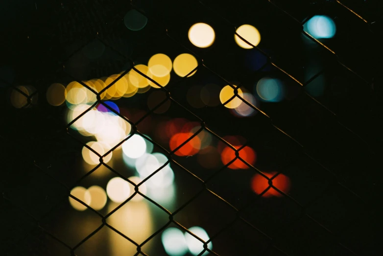 an abstract pograph of light blurs through a fence