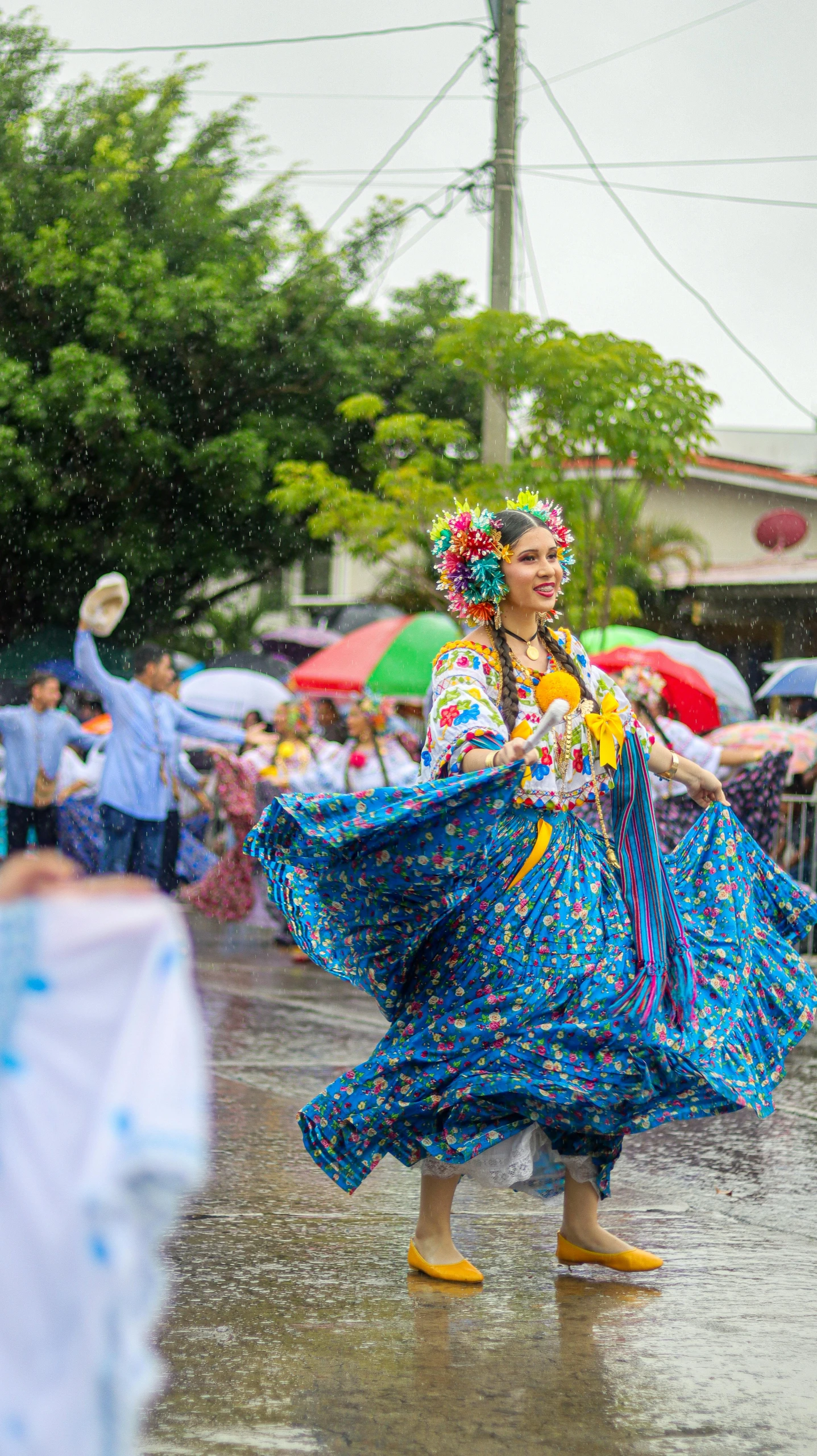 woman in ethnic dress dancing in the rain on a city street