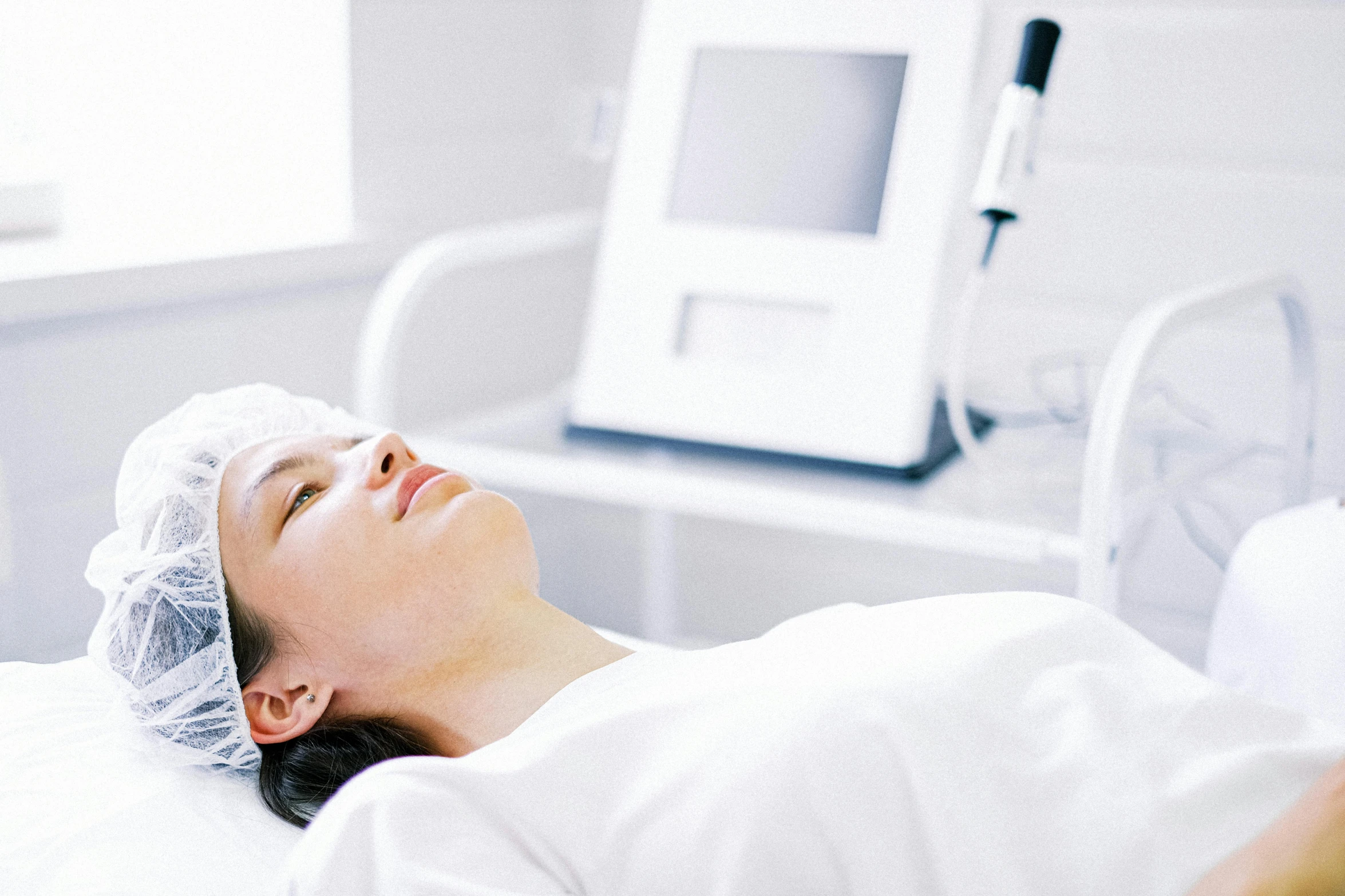 a lady in a hospital bed sleeping on her back