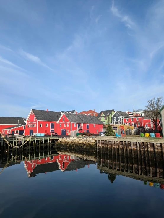 a very colorful house with boats in front of it