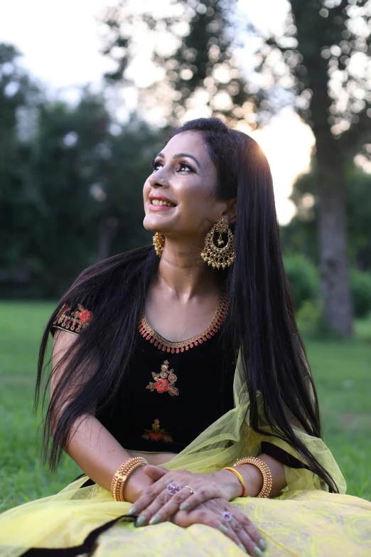 the smiling woman in the black dress poses for the camera