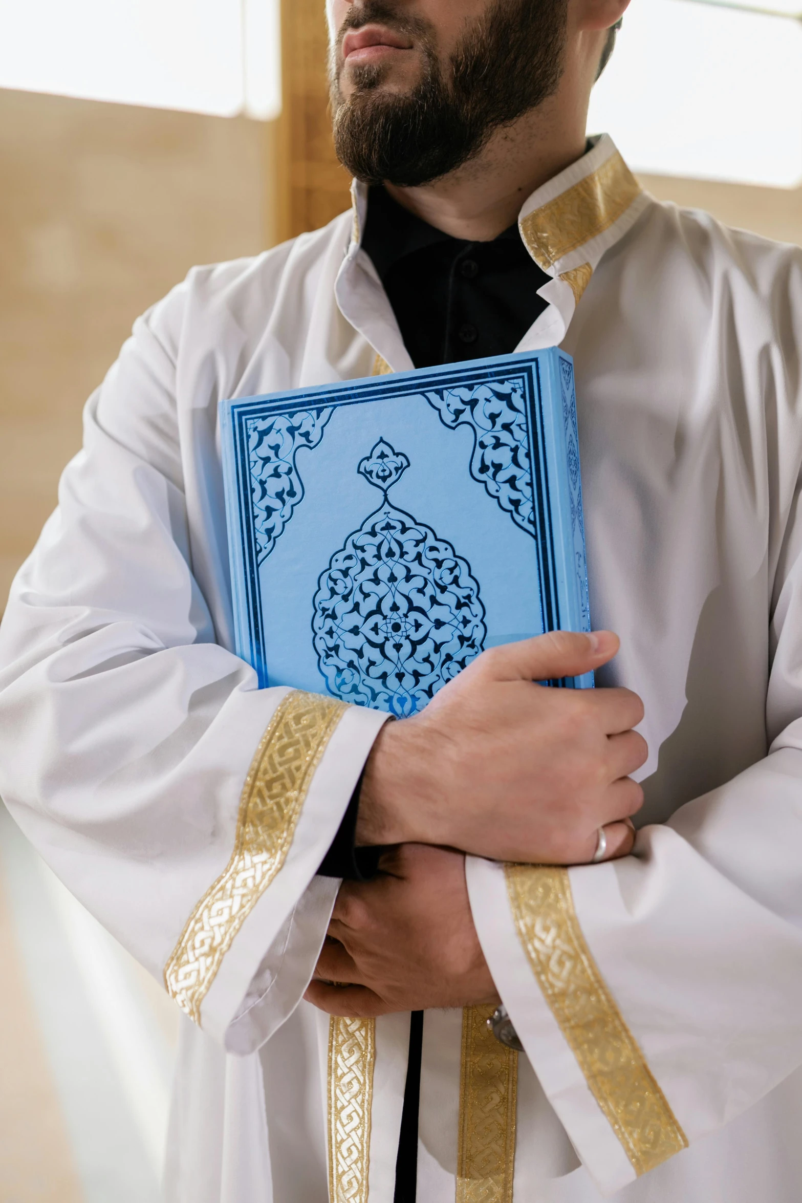 the priest holds a book that reads a prayer