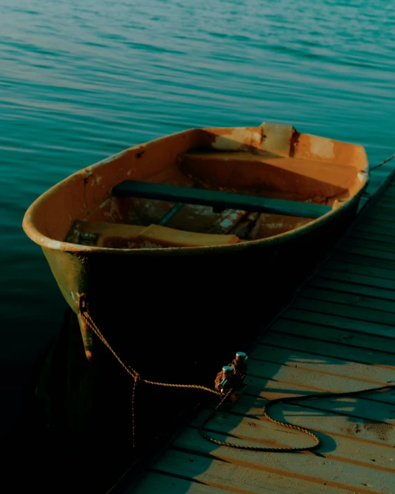 a boat tied to a dock waiting on the water